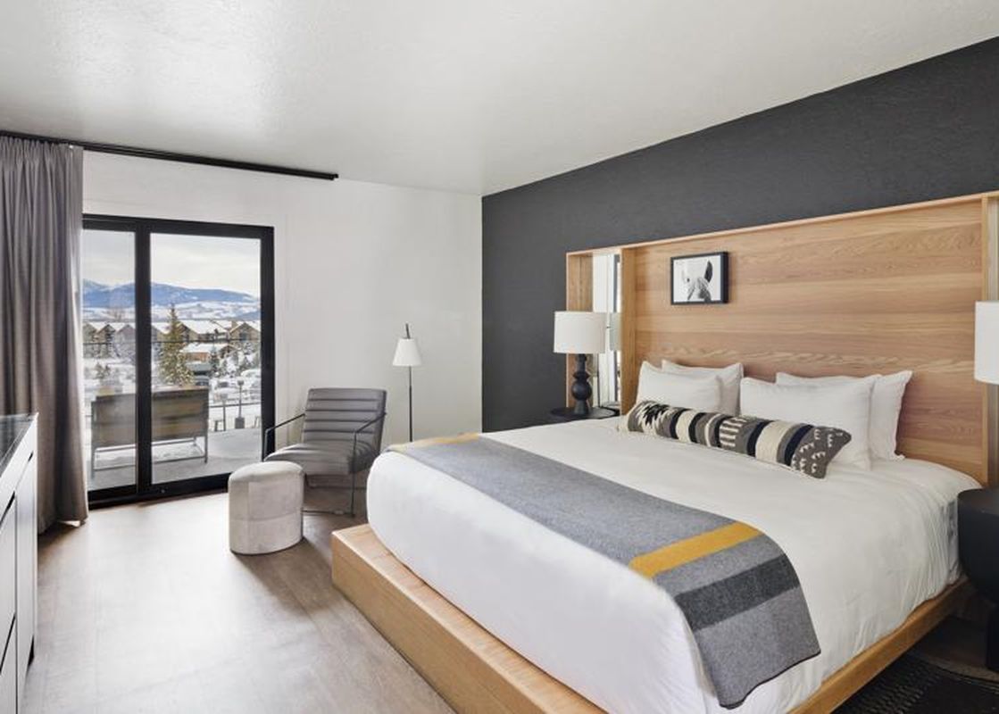 Modern king bedroom with balcony views at Gravity Haus JH Deluxe King.