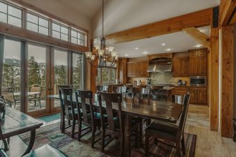 The dining area at Mont Vista Chateau features a long wooden table with seating for ten.