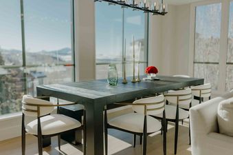 A dining room at Silver Cloud Retreat features mountain views and elegant seating.
