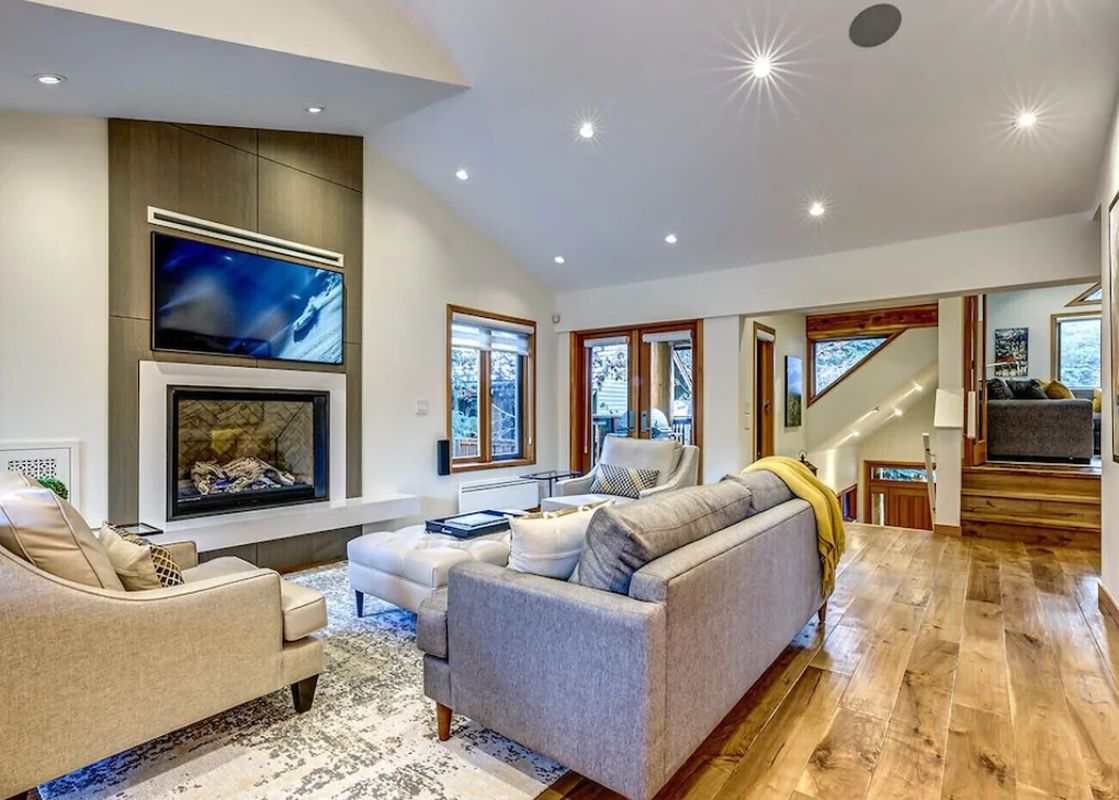 The inviting living room at Cedar Hollow 12 features a fireplace and comfortable seating.