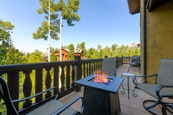 Outdoor seating and a fire pit create a cozy ambiance on the deck of Lost Chalet at Belvedere.