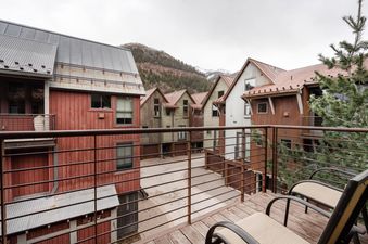 The scenic patio at Owl Meadows 16 overlooks the charming townhomes and surrounding mountains.