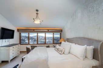Penthouse At The Peaks 826 bedroom featuring a king-size bed and scenic mountain views.