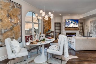 The dining area at Abode at Sky Silver Edge features a stylish oval table set for a feast.