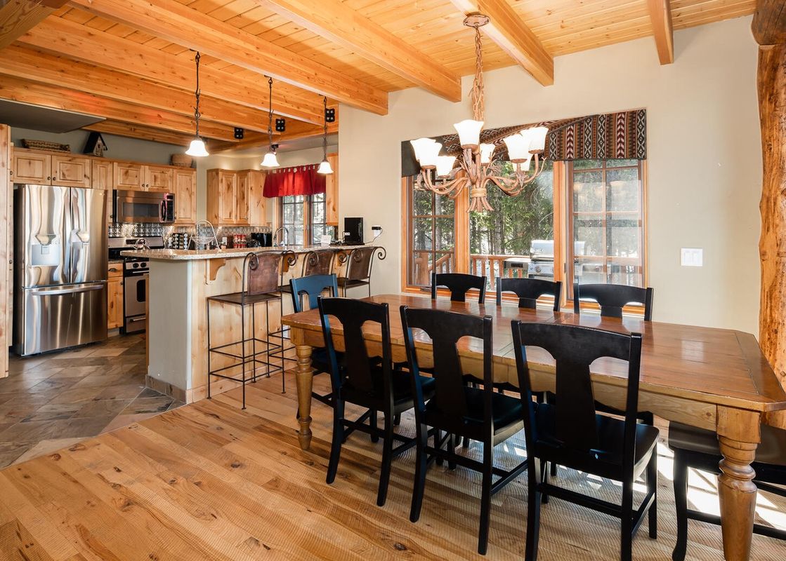 Dining room at Moonlight Basin 6 Mountain Home Road with a large wooden table and chairs