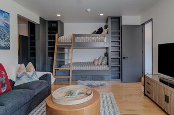 The bunk beds in the second bedroom of Moonlight Basin 17 Lake Cabin are set up with two single mattresses and a small rug on the floor, making the room perfect for kids.