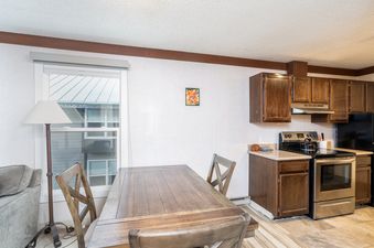 The dining area in Mountainside Inn 413 provides a comfortable place to enjoy a meal.