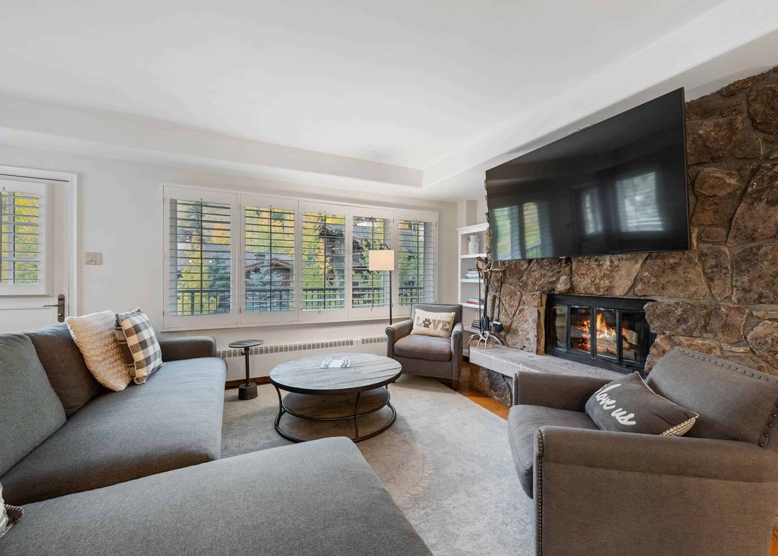The living room in Lodge Tower 487 3 Bedroom features a stone fireplace and comfortable seating.