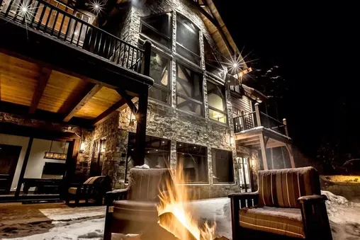 Outdoor fire pit and multiple fireplaces indoors