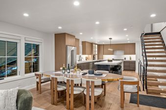 Modern open-concept dining table and gourmet kitchen inside Bluebird Chalet Park City.