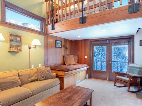 Cozy living room at Manitou Lodge 5, featuring a comfortable couch and rustic decor.