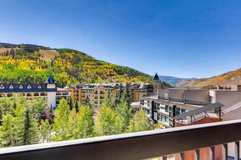 Vail Spa 508 offers a stunning view of the mountains, with fall foliage and a balcony overlooking the resort.