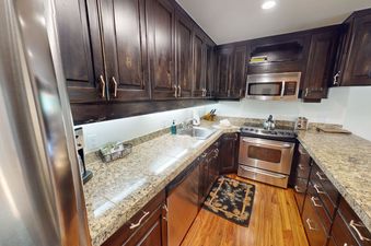 The fully equipped kitchen at Manor Vail 242 features stainless steel appliances and granite countertops.