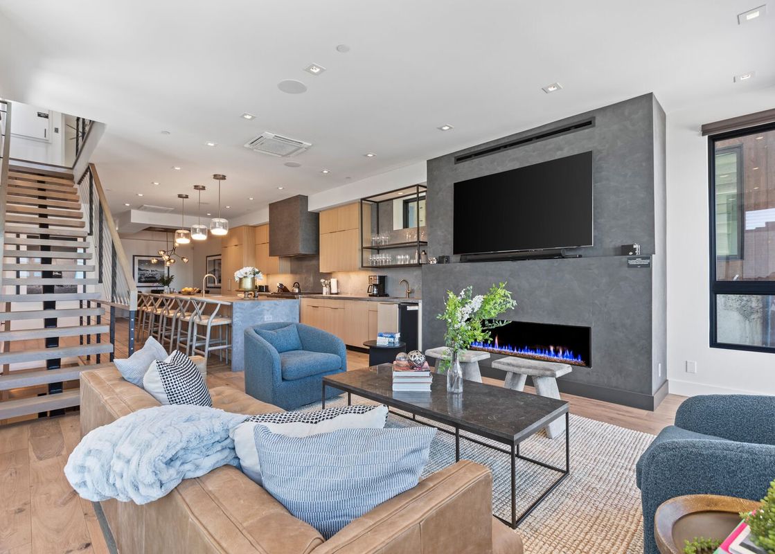Living area in Powder Peak Old Town with fireplace and stairs to the second floor.