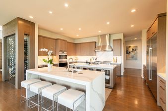 A modern luxury kitchen at Park City Colony Obsidian Ridge featuring two marble-topped islands, premium appliances, and custom wood cabinetry.