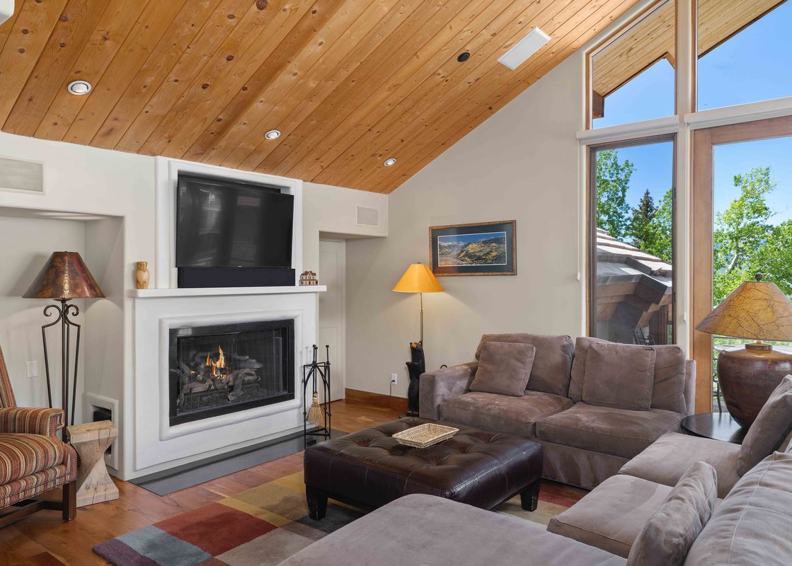 A cozy living area featuring a fireplace and comfortable seating.