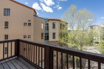 The balcony at Shirana Penthouse 9 offers amazing views of the surrounding trees and architecture.