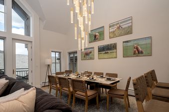 Dining area with a long table and bear artwork in Chalet Montsor.