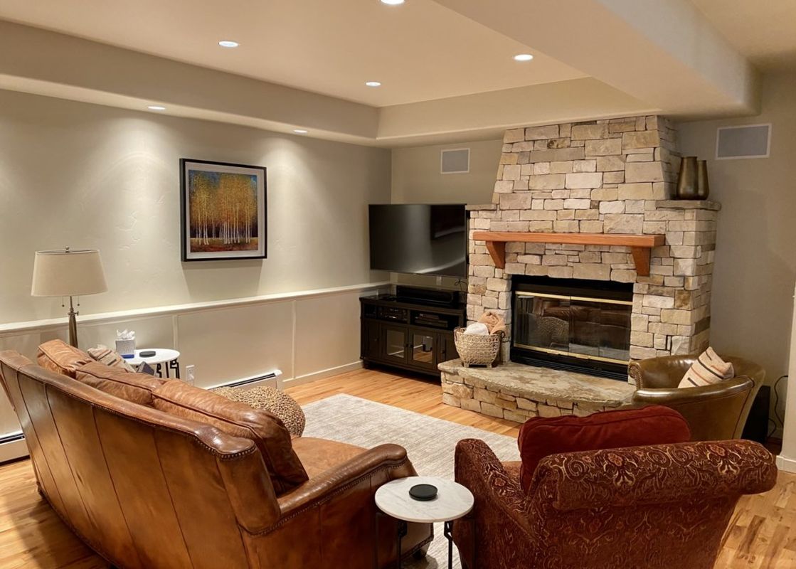 Cozy living room at 226 Country Club Dr with a stone fireplace and comfortable seating.