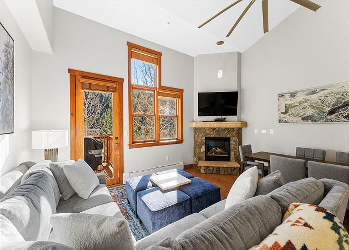 Living area of Red Hawk Townhome 2349 featuring a stone fireplace and comfortable seating.
