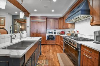 Fully equipped kitchen in Silver Strike Lodge 201 203 featuring wooden cabinetry and high-end appliances.