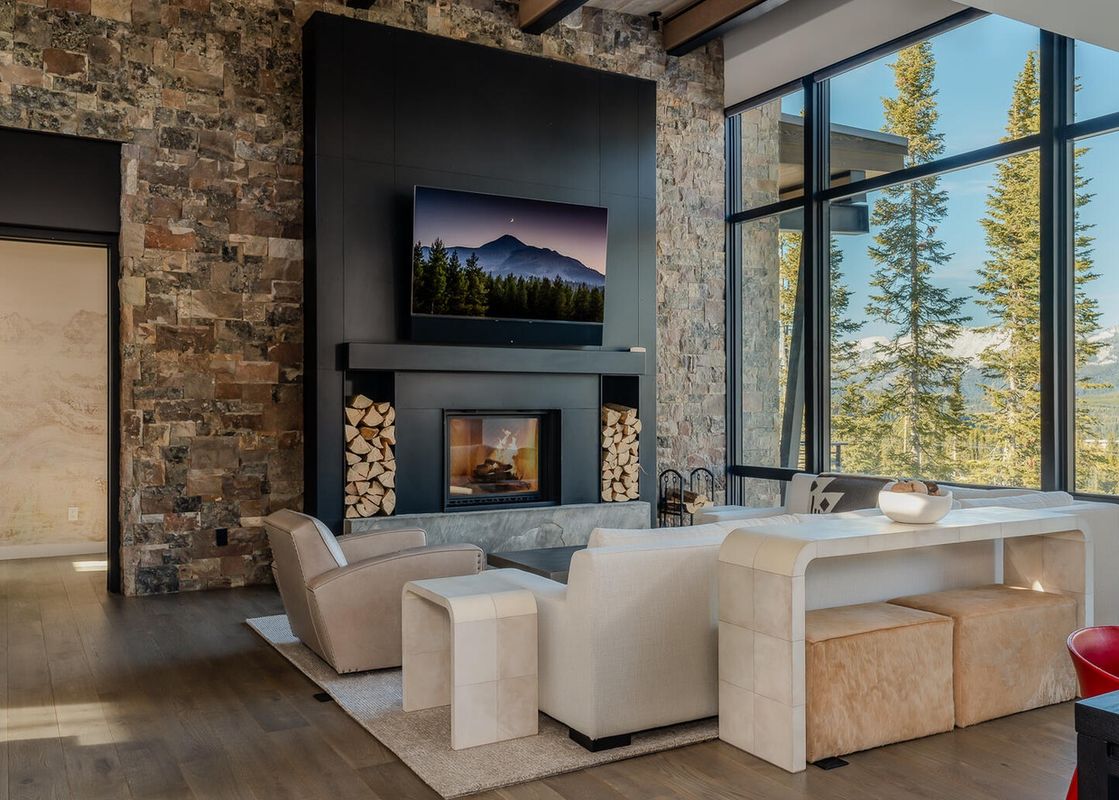 Moonlight Basin 7 Speedwell Drive has a modern living room with large windows that showcase a mountain view.