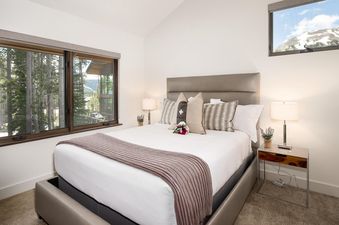 Moonlight Basin 8 Alpine Bend bedroom with a view of the forest outside the window.