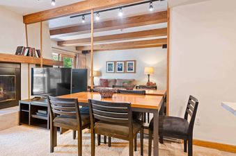 Dining table and chairs in the cozy dining area of Lodge at Lionshead 270A.
