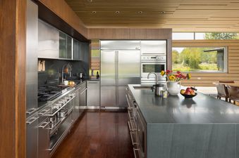 A modern kitchen with stainless steel appliances and a central island at Wilderness Meadow.