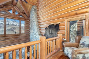 An inviting log cabin interior with mountain views from Villas at Tristant 205.