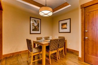 Dining area at One Ski Hill Penthouse with table set for dinner.