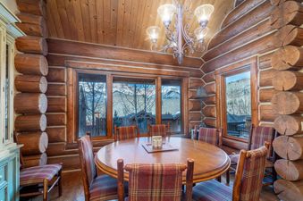 The Villas at Tristant 205 dining area features a round wooden table and mountain views.