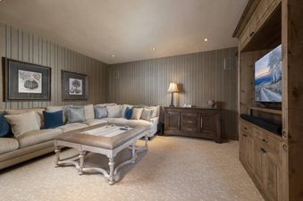 The cozy living room is perfect for relaxing after a day on the slopes. The sectional couch offers ample seating, and the flat-screen TV is perfect for watching a movie.
