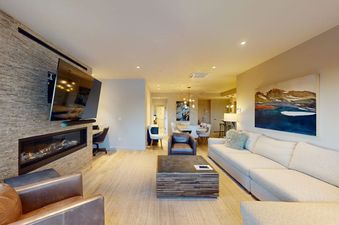 Torian Plum Creekside 714 living room with modern fireplace, sectional sofa, and sleek TV.