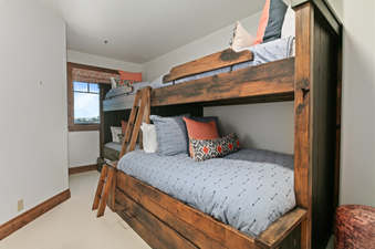 Grand Lodge Three Bedroom Deluxe 308 has a bunk bed with a ladder in a room with a window.