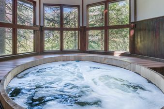 A soothing hot tub experience awaits at Manitou Lodge 9, surrounded by nature.