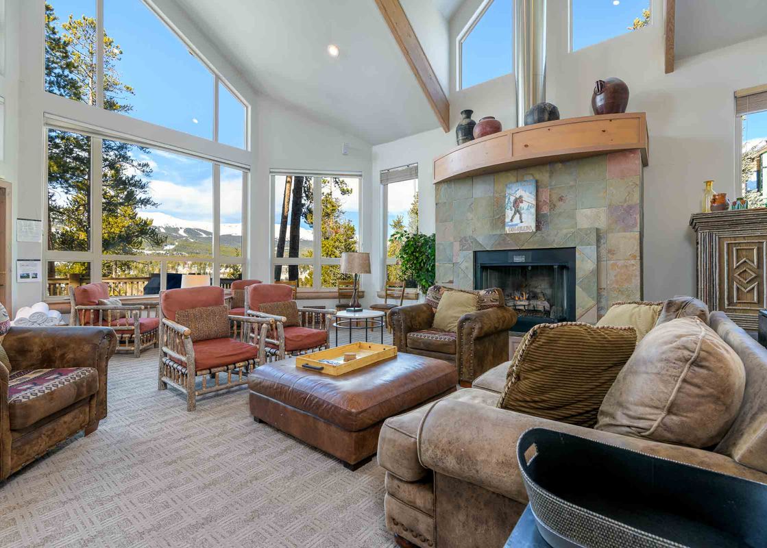 A cozy living room inside Aspenglow Chalet Above Downtown features large windows and comfortable seating.