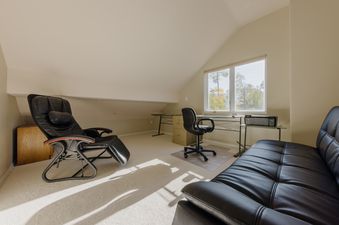 Den and home office space at Crystal Ridge with leather seating, a desk, and a window view.