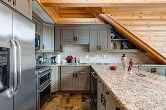 A modern kitchen with stainless steel appliances and a granite countertop.