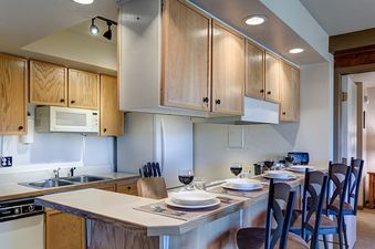 The kitchen and bar area at Bear Claw 1 Slope View 203 is ready for entertaining guests.