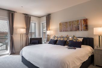 A cozy bedroom at Chalet Montsor offers a serene retreat with plush bedding and soft lighting.