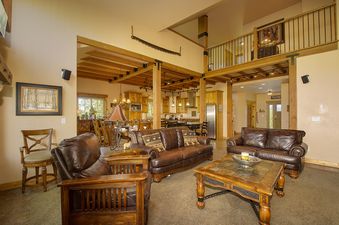 The living area of the Leland Creek Home boasts comfortable leather seating and a cozy atmosphere.