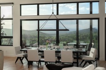 The dining area in Raptor Ridge offers stunning views and elegant seating.