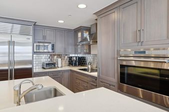 The modern kitchen in Lodge Tower 687 2 Bedroom features stainless steel appliances and sleek cabinetry.