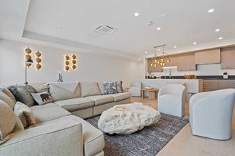 Vail Spa 508 living room features a large, comfortable sectional sofa facing a unique stone coffee table.  The room is decorated in neutral tones and features a modern, minimalist style.