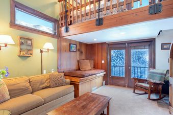 Cozy living room in Manitou Lodge 5 with comfortable seating and natural light.