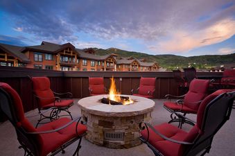 A cozy fire pit surrounded by comfortable chairs at Bear Lodge BL6304.