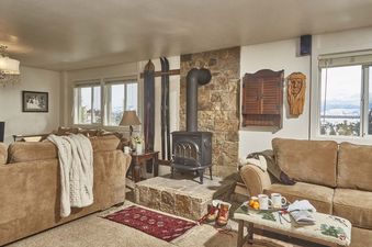 Cozy living room at Gros Ventre B10 featuring a wood-burning stove and mountain views.