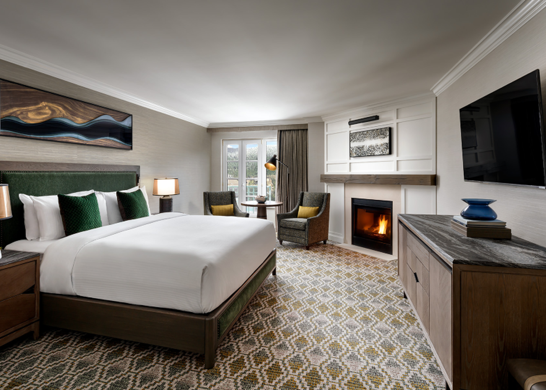 The Fairmont Chateau Gold King Room features a comfortable bed, a cozy seating area, and a fireplace, offering a luxurious and inviting stay.