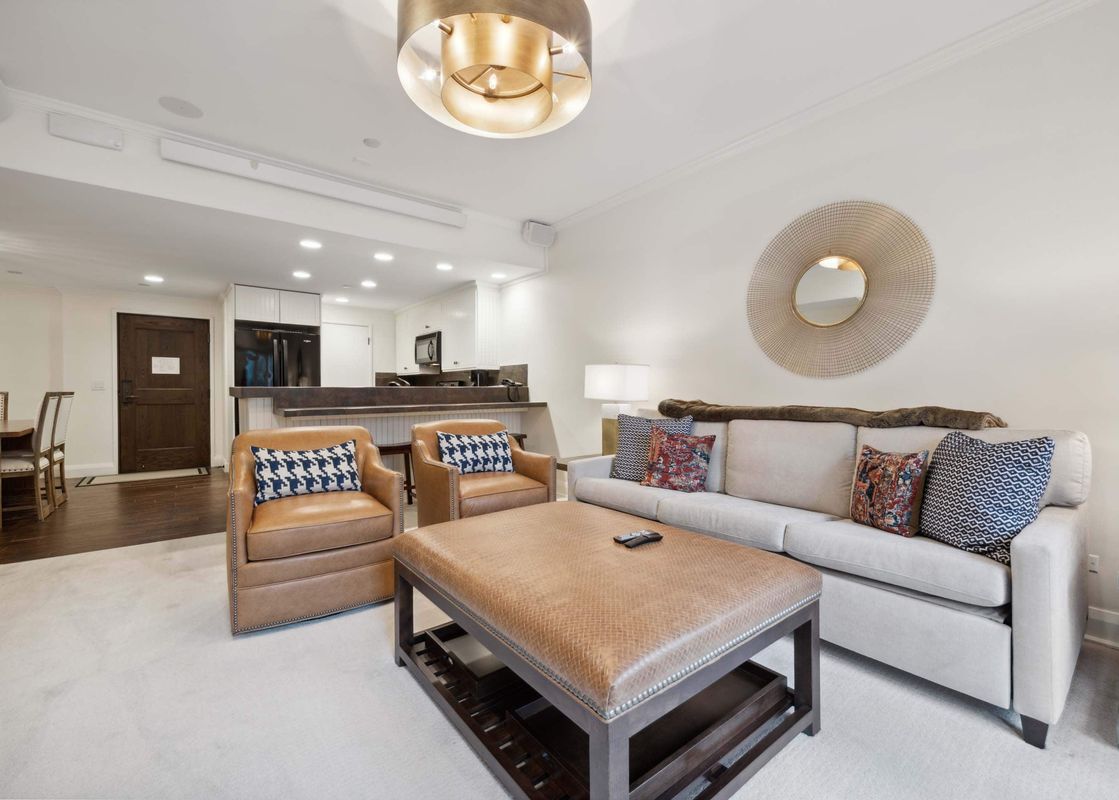 The Charter C1305's elegant living area features plush seating, a large coffee table, and an open-plan design connecting to the kitchen and dining space.